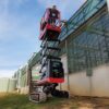 Athena bi-levelling tracked scissor lift working on sloping grass